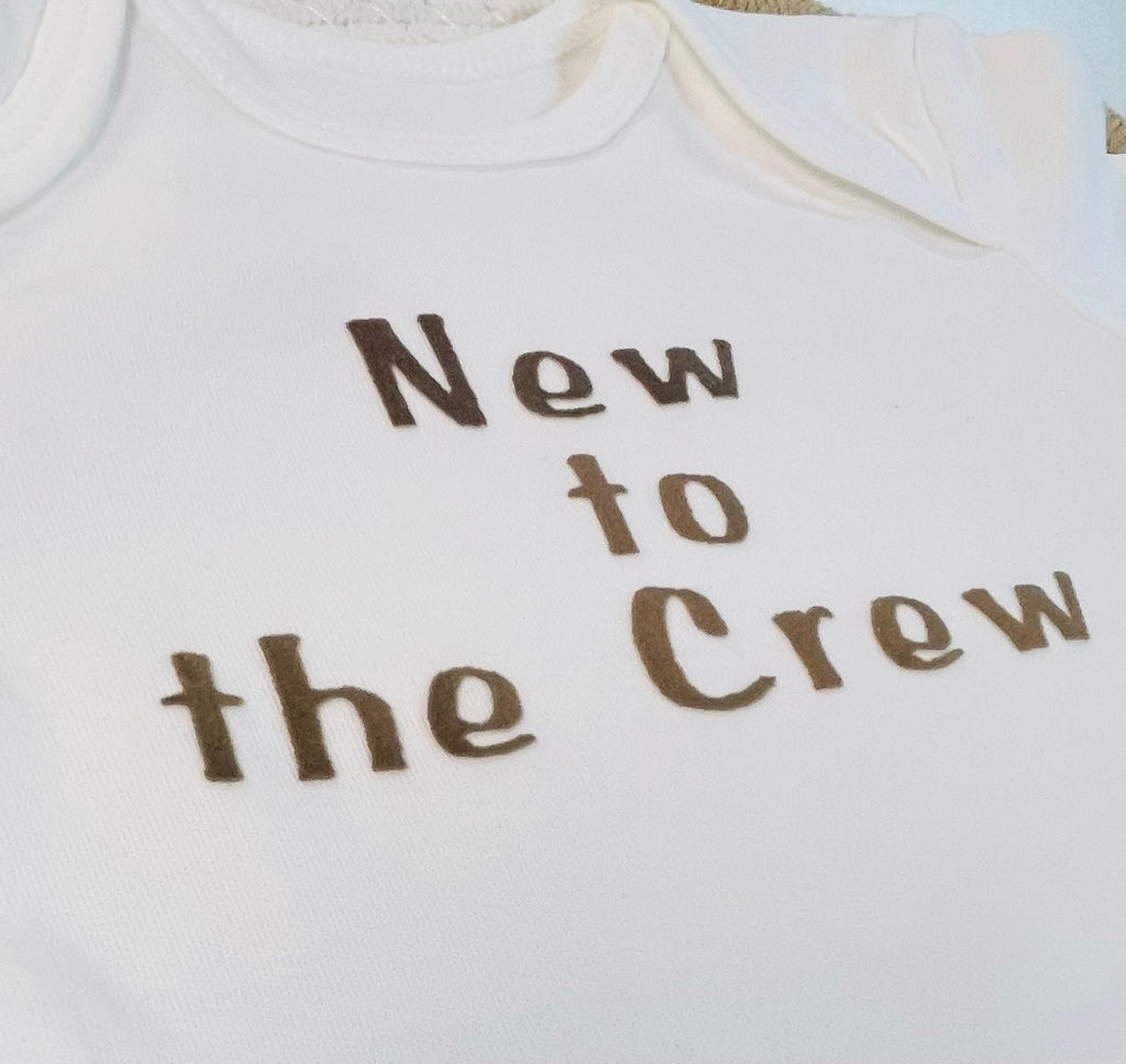 „New to the Crew“ – Dein handgefertigter Willkommens - Body in weiss, veredelt mit einem edlen Braunton * personalisiert mit Flockpatch aus Eigendesign